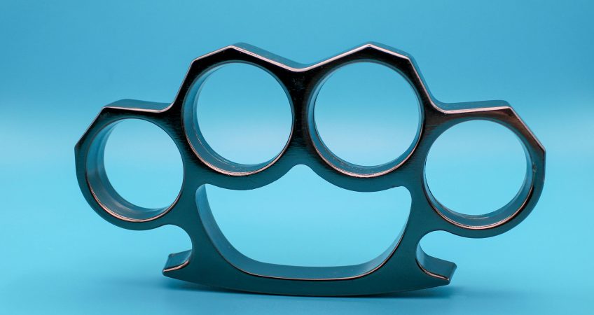 A person facing charges for possession of brass knuckles under California Penal Code 21810 PC.