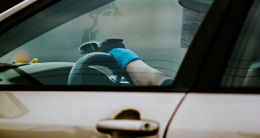 person driving car during daytime
